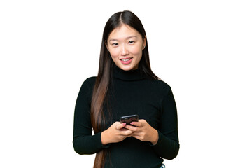 Young Asian woman over isolated chroma key background sending a message with the mobile