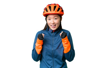 Young cyclist woman over isolated chroma key background celebrating a victory in winner position - obrazy, fototapety, plakaty