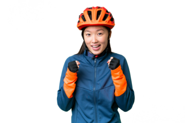 Young cyclist woman over isolated chroma key background celebrating a victory in winner position