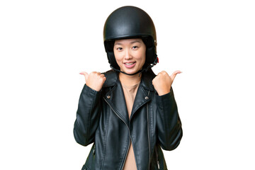 Young Asian woman with a motorcycle helmet over isolated chroma key background with thumbs up gesture and smiling