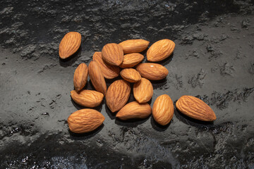 organic almond (prunus dulcis) on stone or concrete background