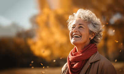 Happy senior fit active woman in the autumn.Portrait of senior woman smiling outdoor. Cheerful old woman in autumn park with copy space. Happy retired lady with grey hair and red beret smiling  - obrazy, fototapety, plakaty