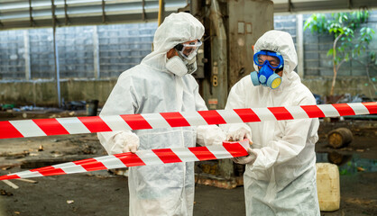 Man inspector scientist investigate chemical gas leak spill with safety face mask PPE suit in area...