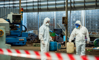 Fototapeta premium Man inspector scientist investigate chemical gas leak spill with safety face mask PPE suit in area closed barricade security red white tape. danger area infected toxic leak spill cross stripe ribbon