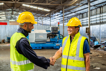 greeting by handshake touch fist and elbow of two engineer supervisor partnership in old factory. foreman greeting friend for good friendship colleague laborer in teamwork factory.