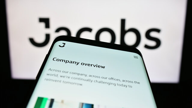 Stuttgart, Germany - 07-29-2023: Smartphone with website of US services company Jacobs Solutions Inc. on screen in front of business logo. Focus on top-left of phone display.