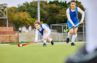 Fitness, workout and female hockey players training for a game, match or tournament on an outdoor field. Sports, exercise and young women playing at practice with a stick and ball on pitch at stadium - Powered by Adobe