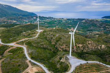 Wind turbine farm for energy production on sunrise sky at seacoast in Turkey