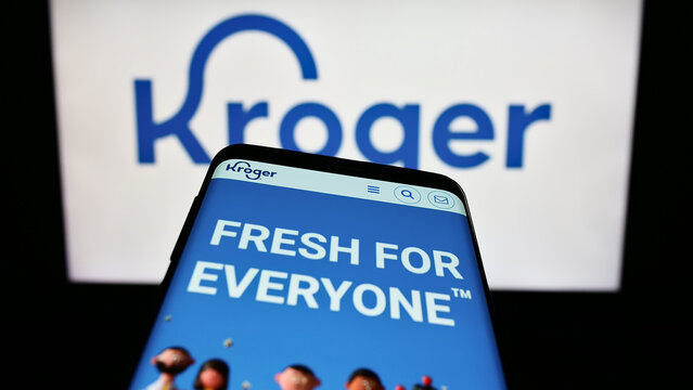 Stuttgart, Germany - 07-30-2023: Smartphone with webpage of US retail business The Kroger Company on screen in front of logo. Focus on top-left of phone display.