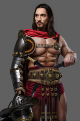 Muscular gladiator with a stylish beard and flowing hair dons intricate lightweight armor, holds a...