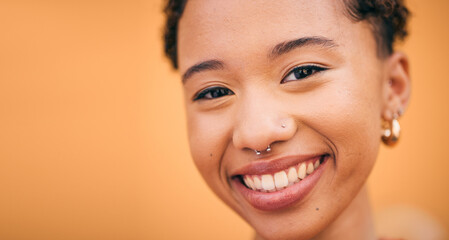 Happy, woman and face closeup in studio with smile and confidence feeling cute. Orange background,...