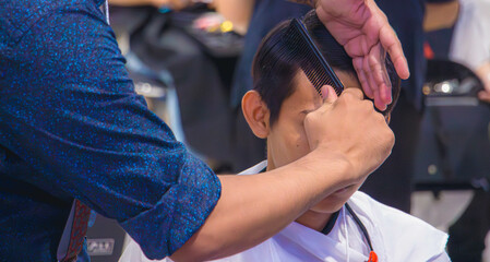 Close-up professional hairdresser using scissors and clippers and accessories for beautiful and decorating men hair Cutting hair for male customer, barbershop fashion and beauty hipster style concept