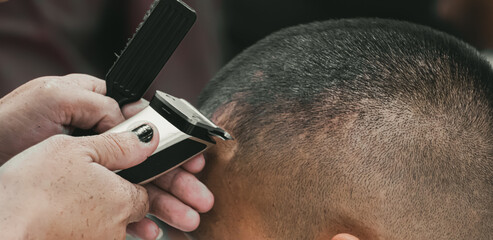 Close-up professional hairdresser using scissors and clippers and accessories for beautiful and decorating men hair Cutting hair for male customer, barbershop fashion and beauty hipster style concept