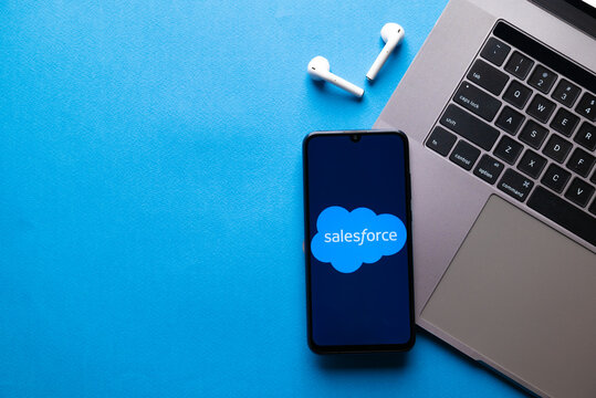 Kyoto city, Japan - July 31, 2023: Salesforce.com displayed on a smartphone near modern laptop on blue background