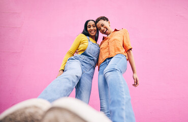 Selfie, fashion and portrait of friends on pink background in city with trendy clothes, stylish and...