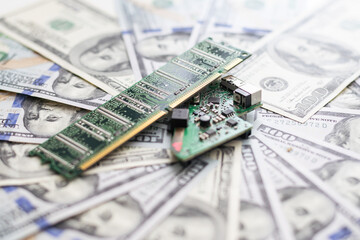 micro chip next to 100 dollar bills