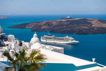 White architecture in Santorini island, Greece. Cruise ship near the coast.