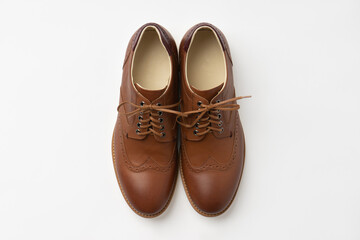Men's leather classic shoes with brown laces. A new pair of shoes on a white background.