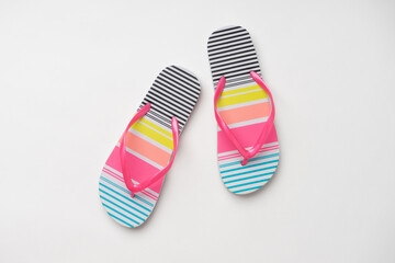 Colorful beach summer women's slippers with colorful stripes. A new pair of shoes on a white background.