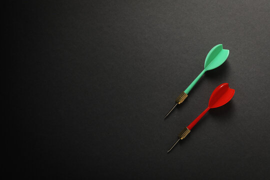 Darts for hitting the target on a dark background.