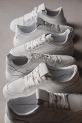 Close up details of white sneakers on the floor. Casual fashion style minimalistic shoes.