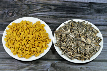 A snack of seeds of the sunflower (Helianthus annuus), Types are linoleic, high oleic and sunflower oil seeds, roasted unpeeled salty Citrullus lanatus watermelon seeds grains, selective focus