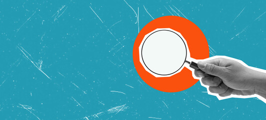 Female hand holding a magnifying glass on a blue background. Layout with blank space for text and...