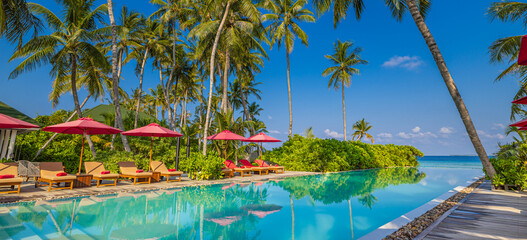 Beachside tourism landscape. Luxurious beach resort poolside. Infinity swimming pool beach chairs...