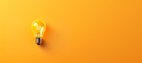 Glowing light bulb, on yellow background. Copy space for text