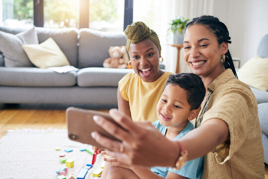Lesbian, women and son in family selfie, smile or care with toys, post or web blog on floor in home living room. Mother, male kid and happy for love, bonding or memory for social network app in house