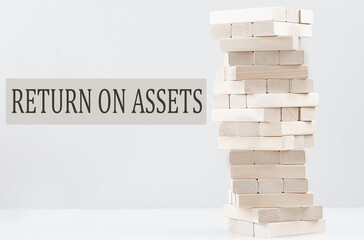 RETURN ON ASSET text with wooden block stack on white background , business concept