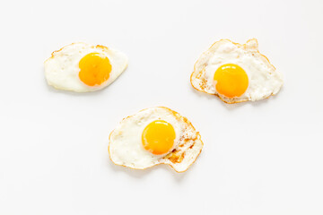 Fried eggs pattern on white background, top view. Breakfast concept
