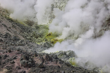 Fototapeta na wymiar Sulphur pieces on Iozan (sulfur mountain) active volcano area, Akan National Park, Hokkaido, Japan