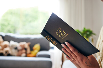 Closeup, bible and hands in home for faith, studying religion or mindfulness with holy spiritual...
