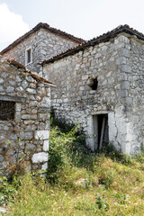 Fototapeta na wymiar Ancient abandoned house complex, stony aged architecture