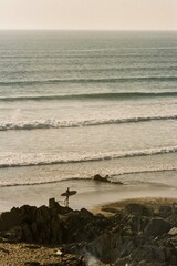 Fototapeta na wymiar surfer walking on the beach