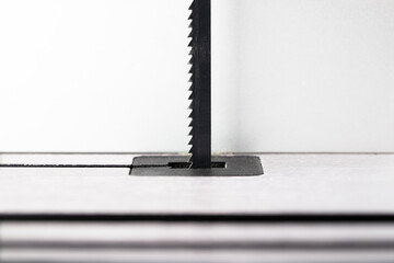 Bandsaw blade with clean saw table. shallow depth of field.