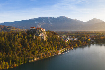 Bled Castle in autumn at sunset in Slovenia aerial view