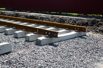 Rusty rails finish their way, the end of the railway track. Repair and laying of new sleepers and rails