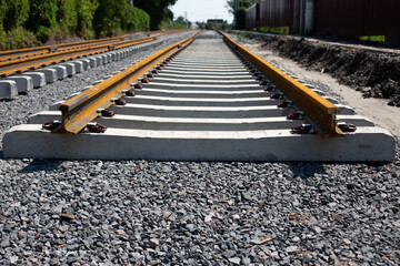 Rusty rails finish their way, the end of the railway track. Repair and laying of new sleepers and...