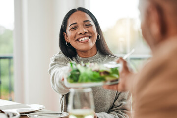 Happy woman, salad and family dinner at thanksgiving celebration at home. Food, female person and eating at a table with a smile from hosting, lunch and social gathering on holiday in dining room - Powered by Adobe