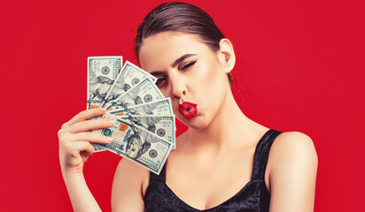 Woman with dollars in hand. Girl holding cash money in dollar banknotes. Woman holding lots of money in dollar currency. Luxury, beauty and money concept