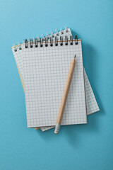 Notepads With Pencil On Blue Background.