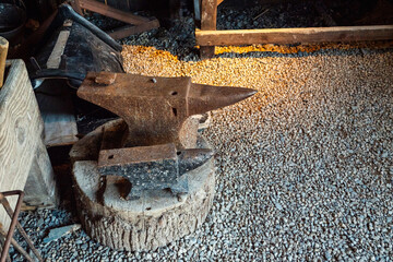 Anvil in a blacksmith shop in a castle museum. Metal forging and tool and weapon production in ancient time.