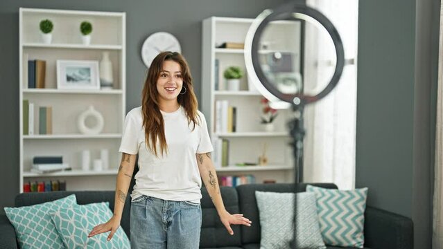 Young beautiful hispanic woman smiling confident recording tutorial dancing at home