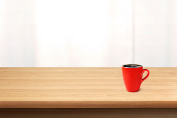 Red coffee cup on wooden table with frosted glass background