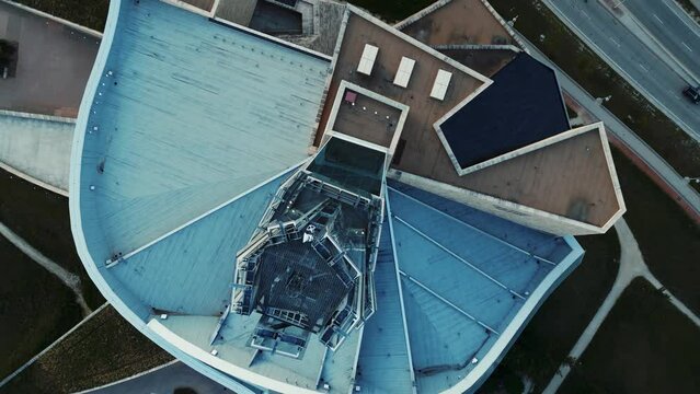 A 4K Top Down Cinematic Landscape Urban City Drone Shot of Downtown Winnipeg Manitoba Canada Orange Sky Sunset Canadian Museum for Human Rights Red River Building Modern Bridge Geometric Architecture