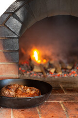 Beef tenderloin baked in a Russian oven in a cast-iron frying pan