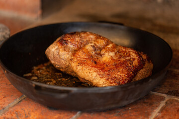 Beef tenderloin baked in an oven in a cast-iron frying pan