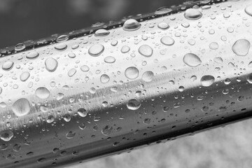 Naklejka na ściany i meble Rain water drops on a stainless steel surface.